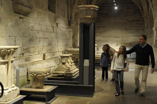 Visitors viewing the exhibit on stone masonry in the cellarium at Maulbronn Monastery